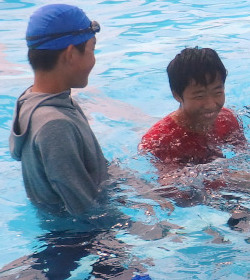 pool lifeguard swimming in uniform clothes